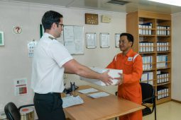 Agent representative from Nakilat Agency hands over a parcel delivery to the Ship’s Captain  at Port
